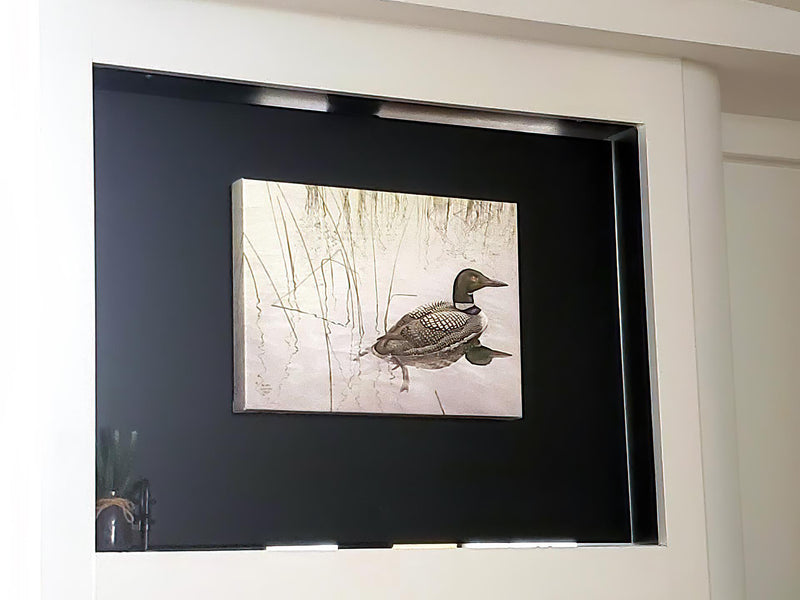 Loon canvas by Glen Loates hanging in a lakeside home
