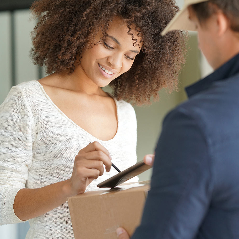 Woman signing package from The Glen Loates Store