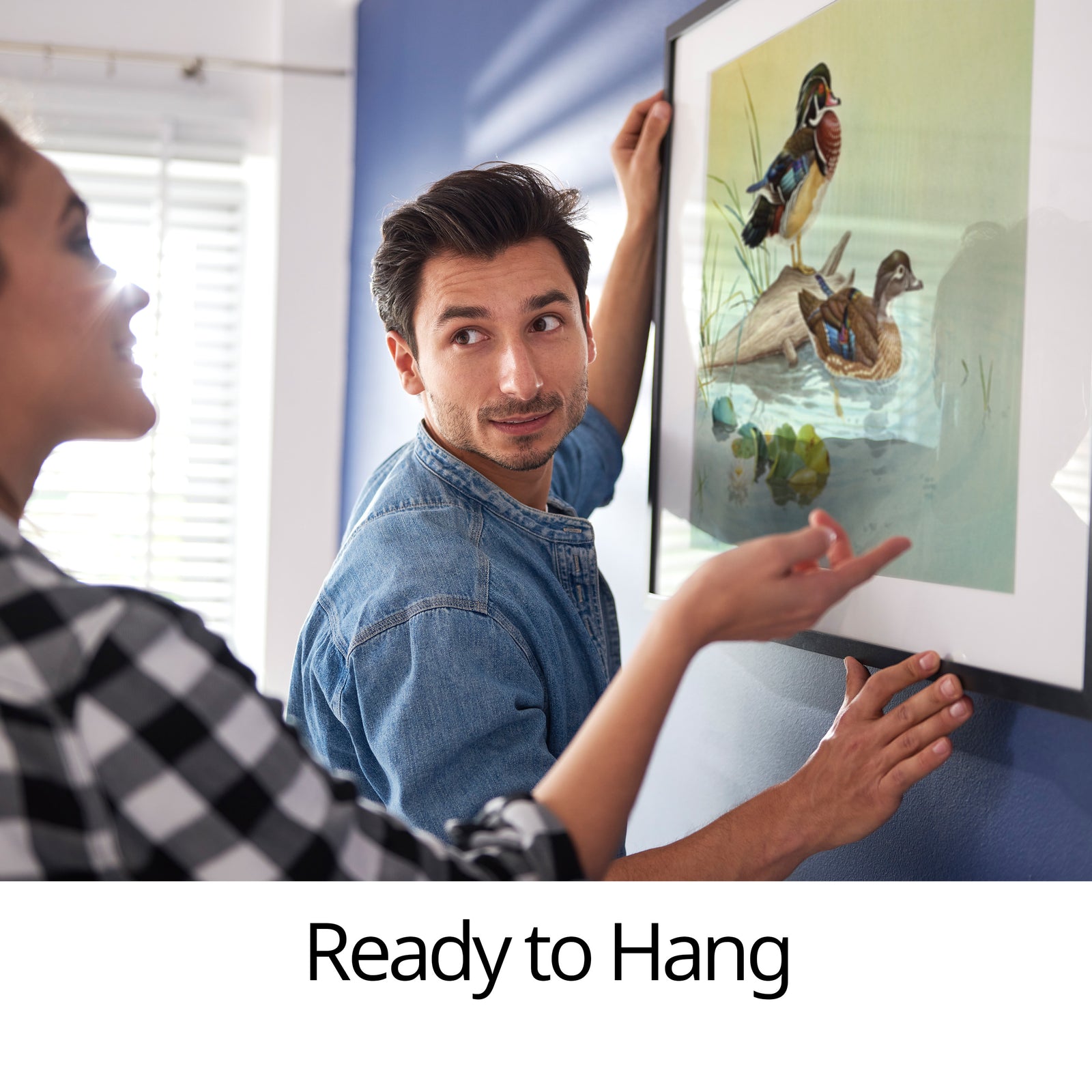 Couple hanging framed picture from The Glen Loates Store